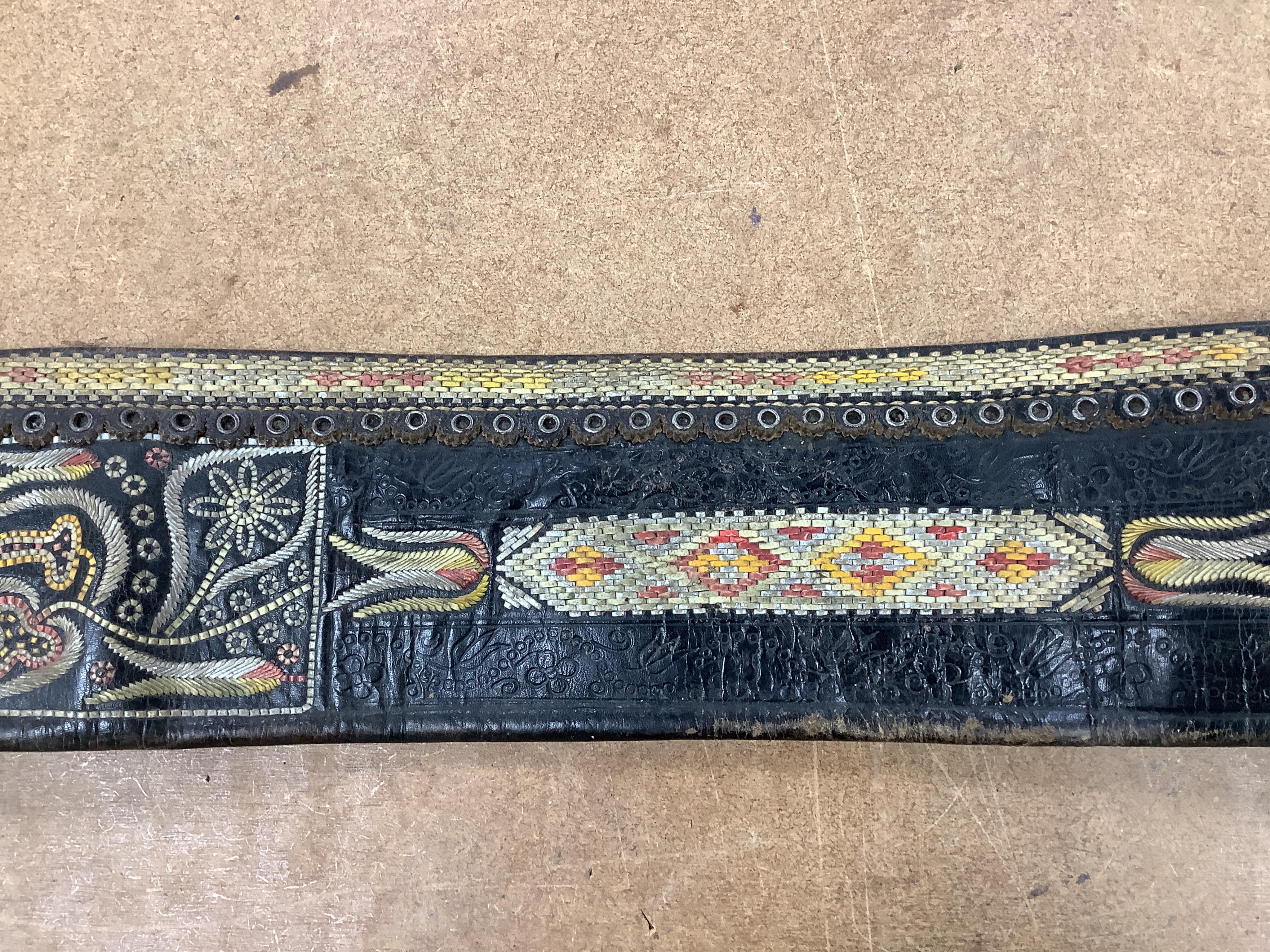 An Argentinian braided leather belt and whips, one with mother of pearl inlay